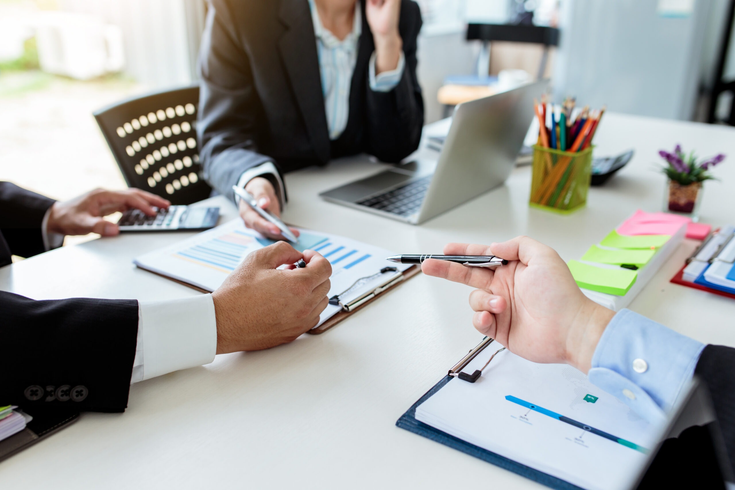 Teamwork process, business people working in the office discussing documents and ideas at meeting